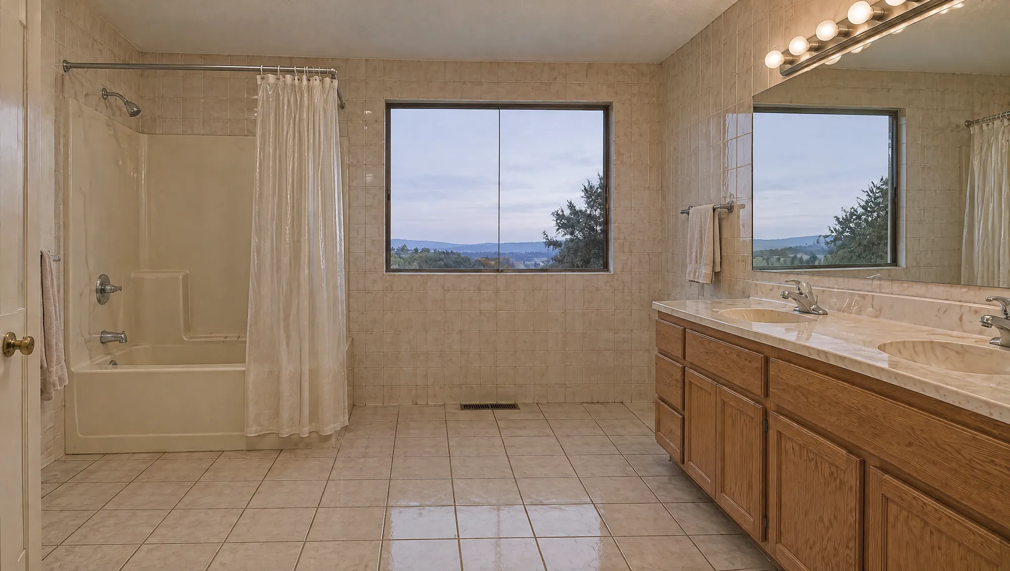 Bathroom before: beige tile, fiberglass tub-shower and oak vanity